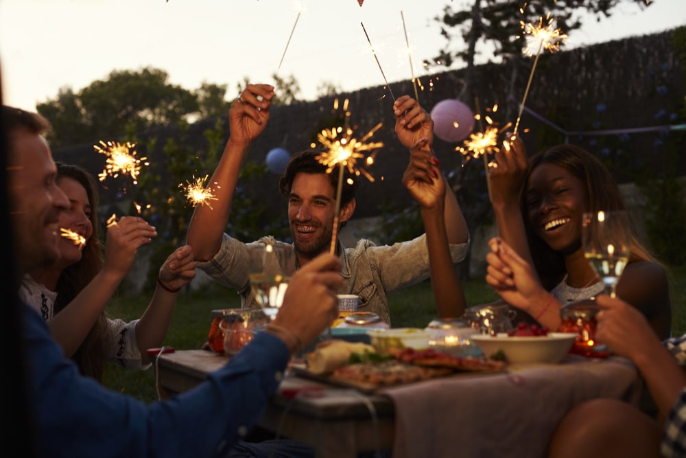 Group of friends celebrating New Years Eve with food and drinks